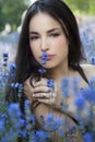 Beautiful young woman i blue flower field Royalty Free Stock Photo