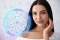 Beautiful young woman and illustration of zodiac wheel with astrological signs on light background