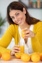 beautiful young woman juicing oranges for vitamin c