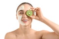 Beautiful young woman with kiwi facial mask on white background