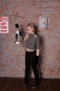 Beautiful young woman posing near brick wall Royalty Free Stock Photo