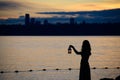 Beautiful young woman with lantern waiting on the lake in twilig Royalty Free Stock Photo