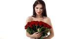 Beautiful young woman with a large bouquet of red roses Royalty Free Stock Photo