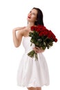 Beautiful young woman with a large bouquet of red roses Royalty Free Stock Photo