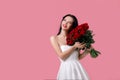 Beautiful young woman with a large bouquet of red roses Royalty Free Stock Photo