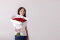 Beautiful young woman with a large bouquet of red roses Royalty Free Stock Photo