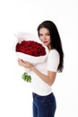 Beautiful young woman with a large bouquet of red roses Royalty Free Stock Photo