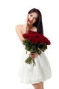 Beautiful young woman with a large bouquet of red roses Royalty Free Stock Photo