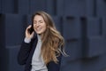 Beautiful young woman laughing while making a phone call Royalty Free Stock Photo