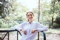 Beautiful young woman laughing and sitting at public park in the morning,Happy and smiling,Relaxing time,Positive thinking Royalty Free Stock Photo