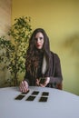 Young woman lays out cards on the table