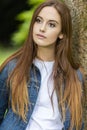 Beautiful Young Woman Leaning Against Tree Royalty Free Stock Photo