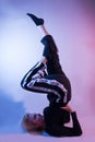 Graceful Elegance: Young Woman Showcasing Gymnastic Skills in Vibrant Ambiance