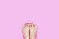 Beautiful Young Woman Legs and Feet on Pink Color, Copy Space. Beauty Manicure and Pedicure Bare Feet. Nails and Soft. Female is Royalty Free Stock Photo