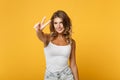Beautiful young woman in light casual clothes posing isolated on yellow orange wall background, studio portrait. People Royalty Free Stock Photo