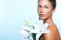 Beautiful young woman with with lily flowers, female face and sh