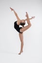 Beautiful young woman limber exerciser in the studio