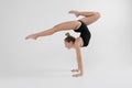 Beautiful young woman limber exerciser in the studio