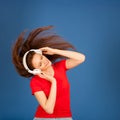 Beautiful young woman listen to the music and dance over vibrant Royalty Free Stock Photo