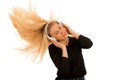 Beautiful young woman listens to the music on headphones and dan Royalty Free Stock Photo