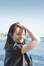 Beautiful young woman with long black hair smiling in the city Royalty Free Stock Photo