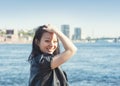 Beautiful young woman with long black hair smiling in the city Royalty Free Stock Photo