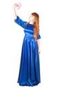 Beautiful young woman in a long blue evening dress with a small Royalty Free Stock Photo