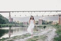 Beautiful young woman with long curly hair dressed in boho style dress posing near lake Royalty Free Stock Photo