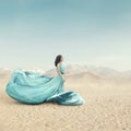 Beautiful young woman in long fluttering dress posing outdoor Royalty Free Stock Photo