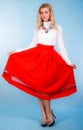 Beautiful young woman in a long red skirt