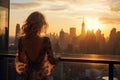 Beautiful young woman with long wavy blond hair looking at New York City skyline at sunset, Rich woman rear view enjoy the sunset Royalty Free Stock Photo