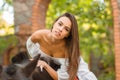 Beautiful young woman in a long white dress with brown horse outdoor. Royalty Free Stock Photo