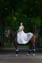 Beautiful girl in dress sitting on horse Royalty Free Stock Photo