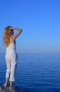 Beautiful young woman looking at the sea Royalty Free Stock Photo