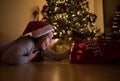 Beautiful young woman looking surprised at her christmas present