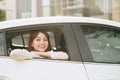 Beautiful young woman, looks out the window a white car Royalty Free Stock Photo