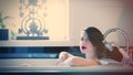 beautiful young woman lying in the bath and relaxing in the luxury bathroom Royalty Free Stock Photo