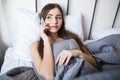 Beautiful young woman lying on bed, talking on mobile phone Royalty Free Stock Photo