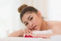 Beautiful young woman lying down on the bed relax in spa salon with massage Royalty Free Stock Photo