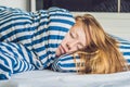 Beautiful young woman lying down in bed and sleeping. Do not get enough sleep concept