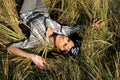 Beautiful young woman lying on field Royalty Free Stock Photo