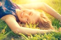 Beautiful young woman lying on the field Royalty Free Stock Photo