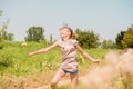 Beautiful Young Woman lying on the field in green grass and blowing dandelion. Outdoors. Enjoy Nature. Healthy Smiling Girl on spr Royalty Free Stock Photo