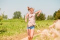 Beautiful Young Woman lying on the field in green grass and blowing dandelion. Outdoors. Enjoy Nature. Healthy Smiling Girl on spr Royalty Free Stock Photo