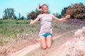 Beautiful Young Woman lying on the field in green grass and blowing dandelion. Outdoors. Enjoy Nature. Healthy Smiling Girl on spr Royalty Free Stock Photo