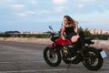 Beautiful young woman lying on a motorcycle Royalty Free Stock Photo