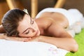 Beautiful young woman lying on massage table.