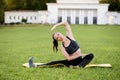 Beautiful young woman lying on a yellow mattress doing pilates or yoga, the saw exercises Royalty Free Stock Photo