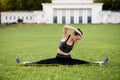 Beautiful young woman lying on a yellow mattress doing pilates or yoga, the saw exercises Royalty Free Stock Photo