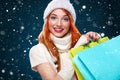 Christmas and New Year holidays.. Shopping woman holding color bags and on winter background with snow in black friday Royalty Free Stock Photo